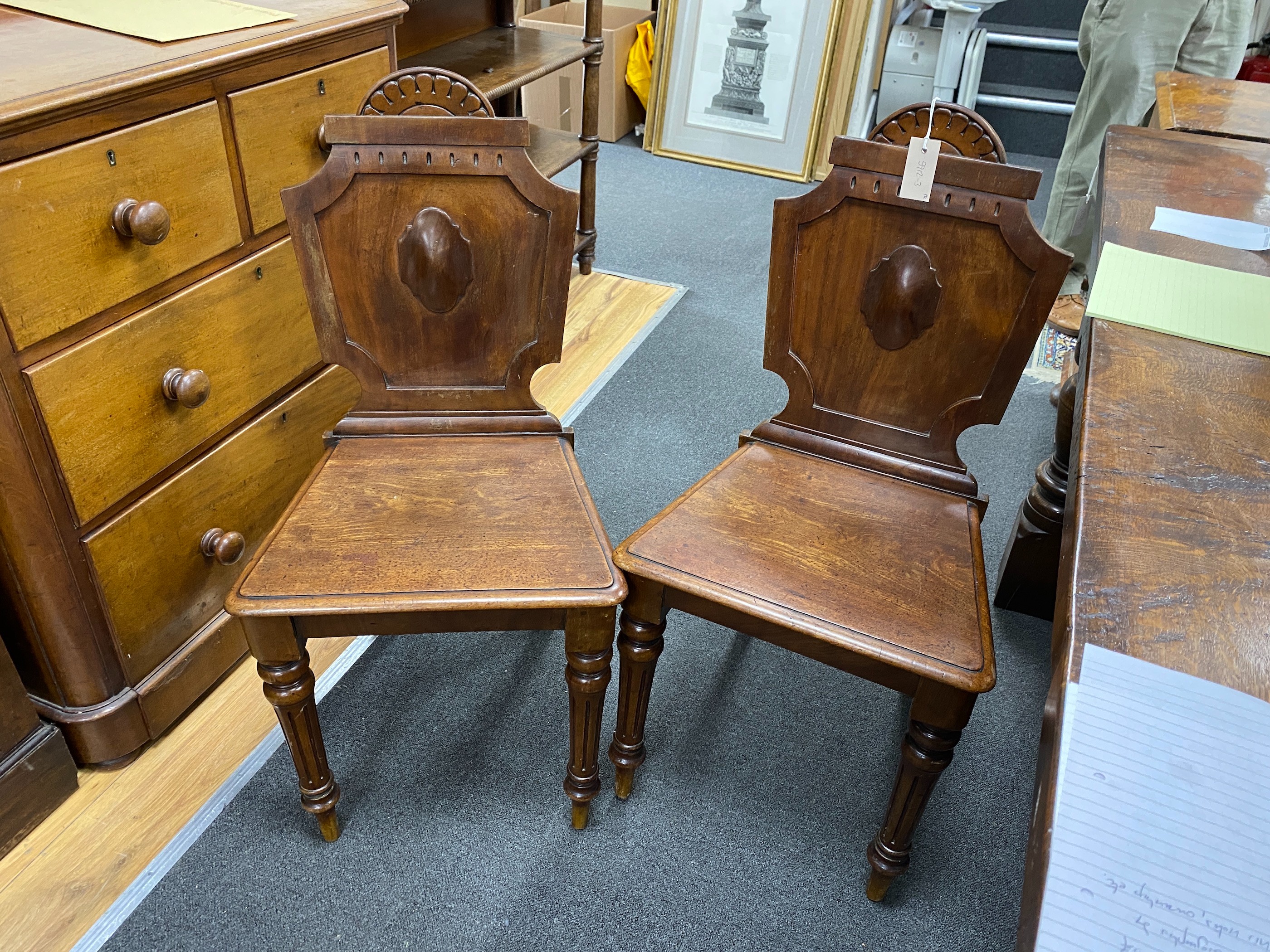 A pair of Victorian mahogany hall chairs